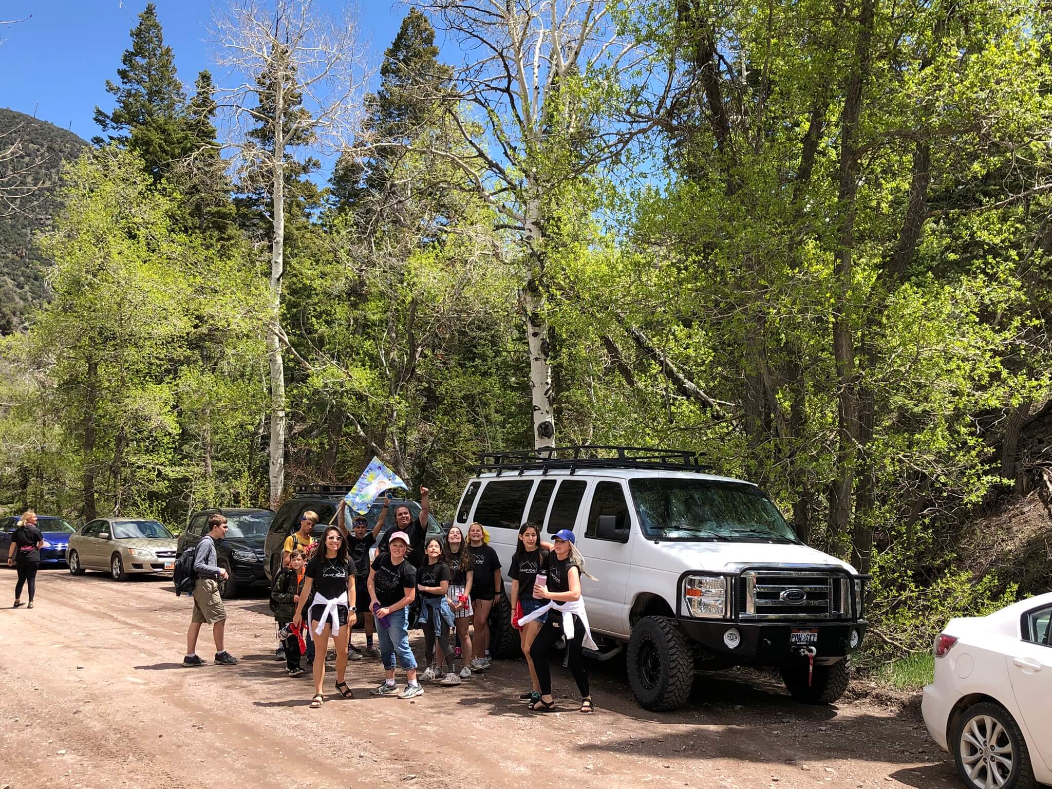 Campers being dropped off at a hiking trail. 